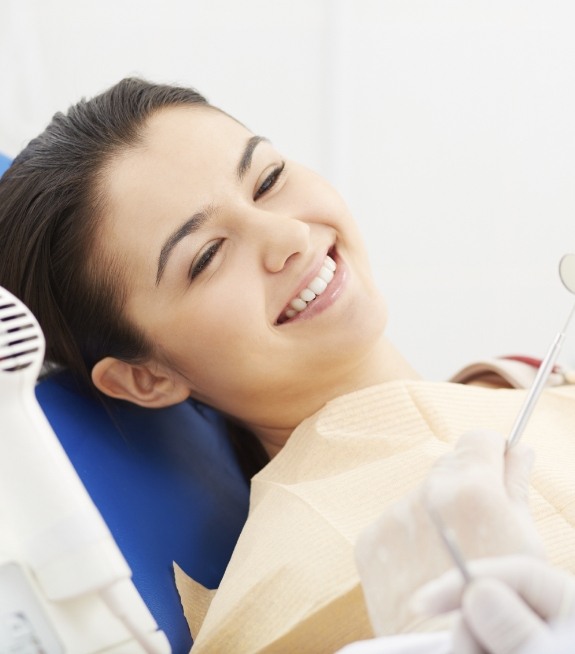 Woman smiling at her dentist during a dental checkup