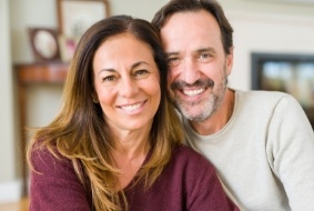 Man and woman smiling together in their living room