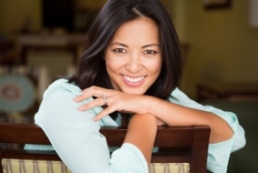 Smiling woman leaning over the back of her chair