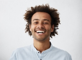 Smiling man in pale blue shirt