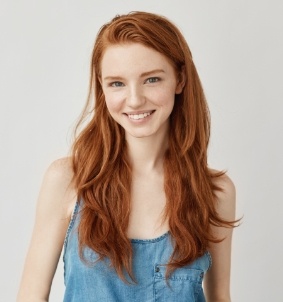 Smiling young woman with orange hair