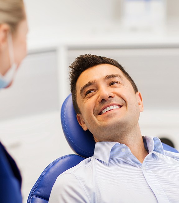 Man smiles at dentist