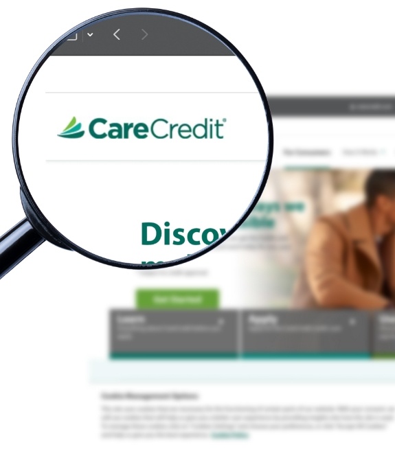 Magnifying glass showing Care Credit logo on their website