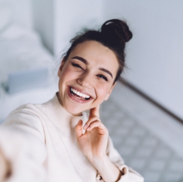 Smiling brunette woman with her hair in a bun