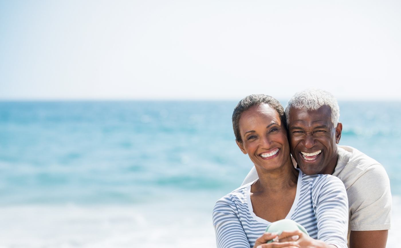 Older man and woman smiling outdoors after restorative dentistry in Julington Creek